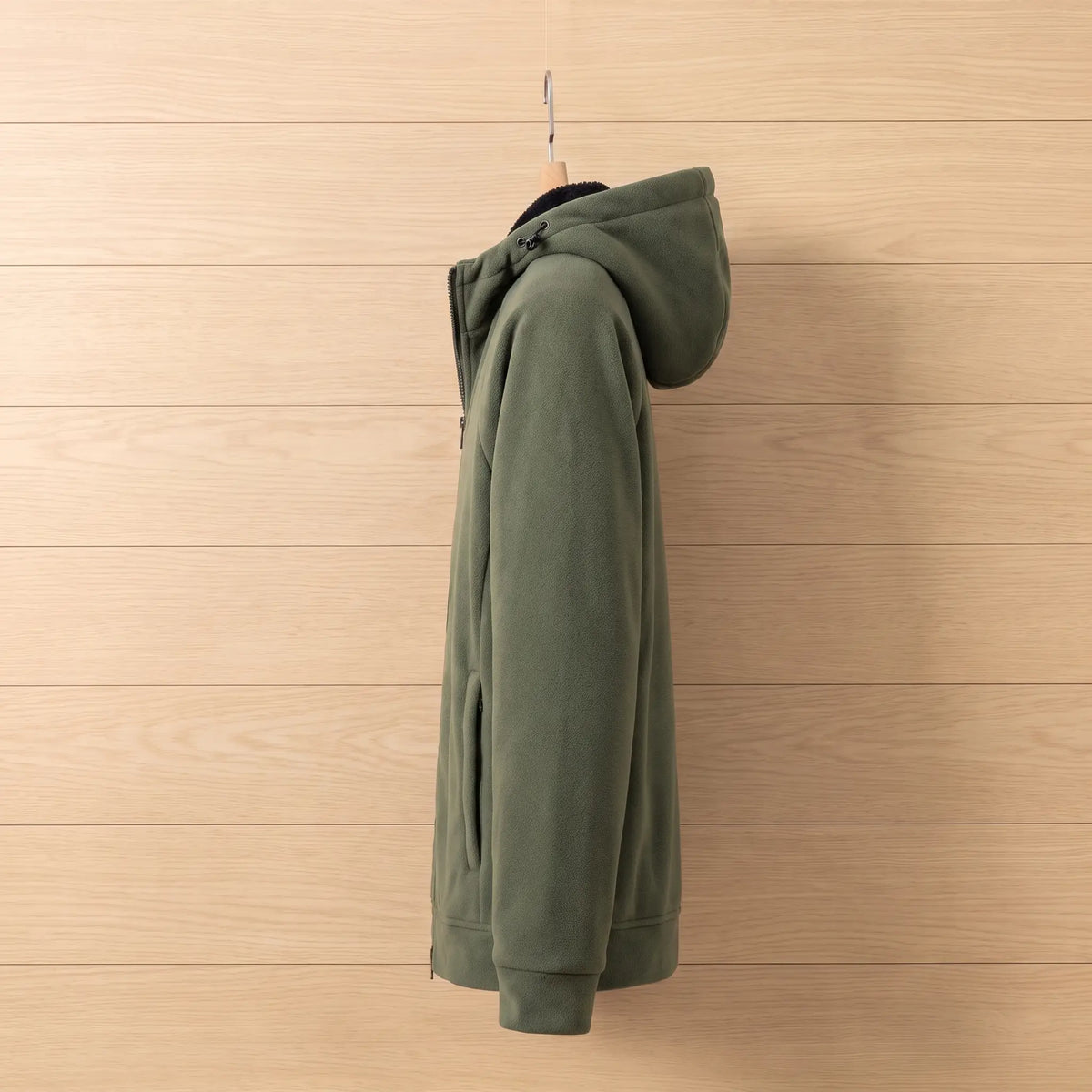 Side view of green hooded fleece jacket on a wooden hanger