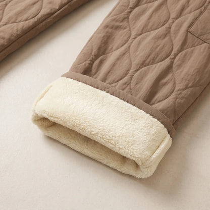 Close up of the COSY QUILTED TROUSERS hem turned up to show the cream plush lining