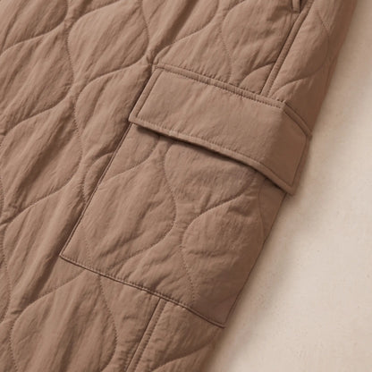 Close up of the COSY QUILTED TROUSERS flap cargo pocket and quilting