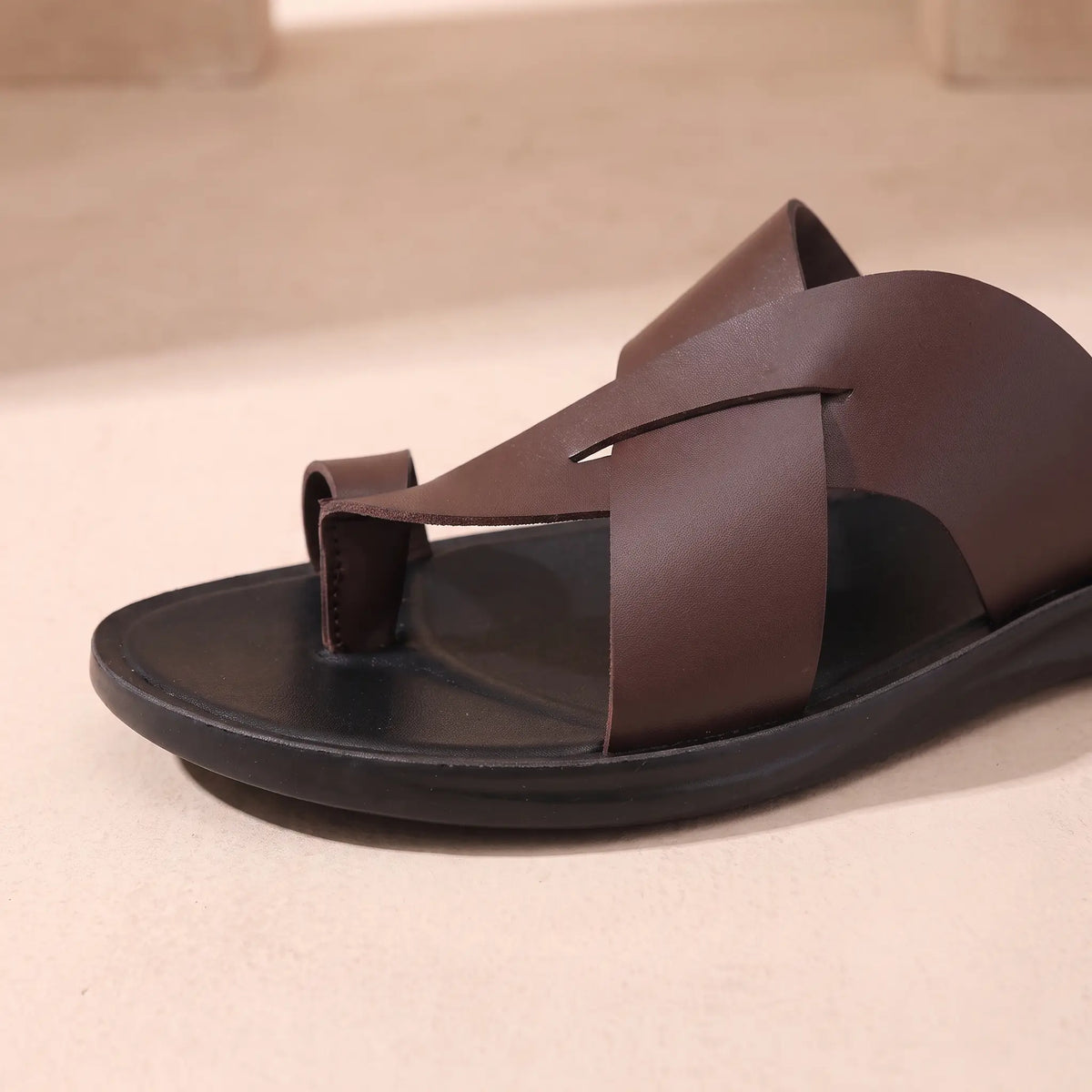 Close up of the crossing bands and toe loop on a brown mens backless slide