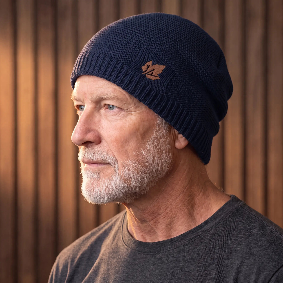 Navy blue cuffed knit beanie for men worn with a turn-up cuff over the ears
