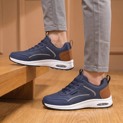 Cushion Step Trainers in Navy Blue worn as a pair with grey chinos