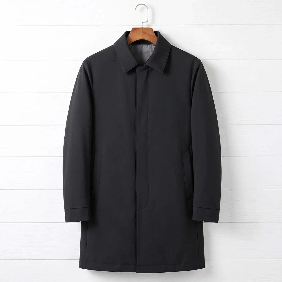 Black down lined coat for men, mid-thigh car coat with hidden buttons on a wooden hanger