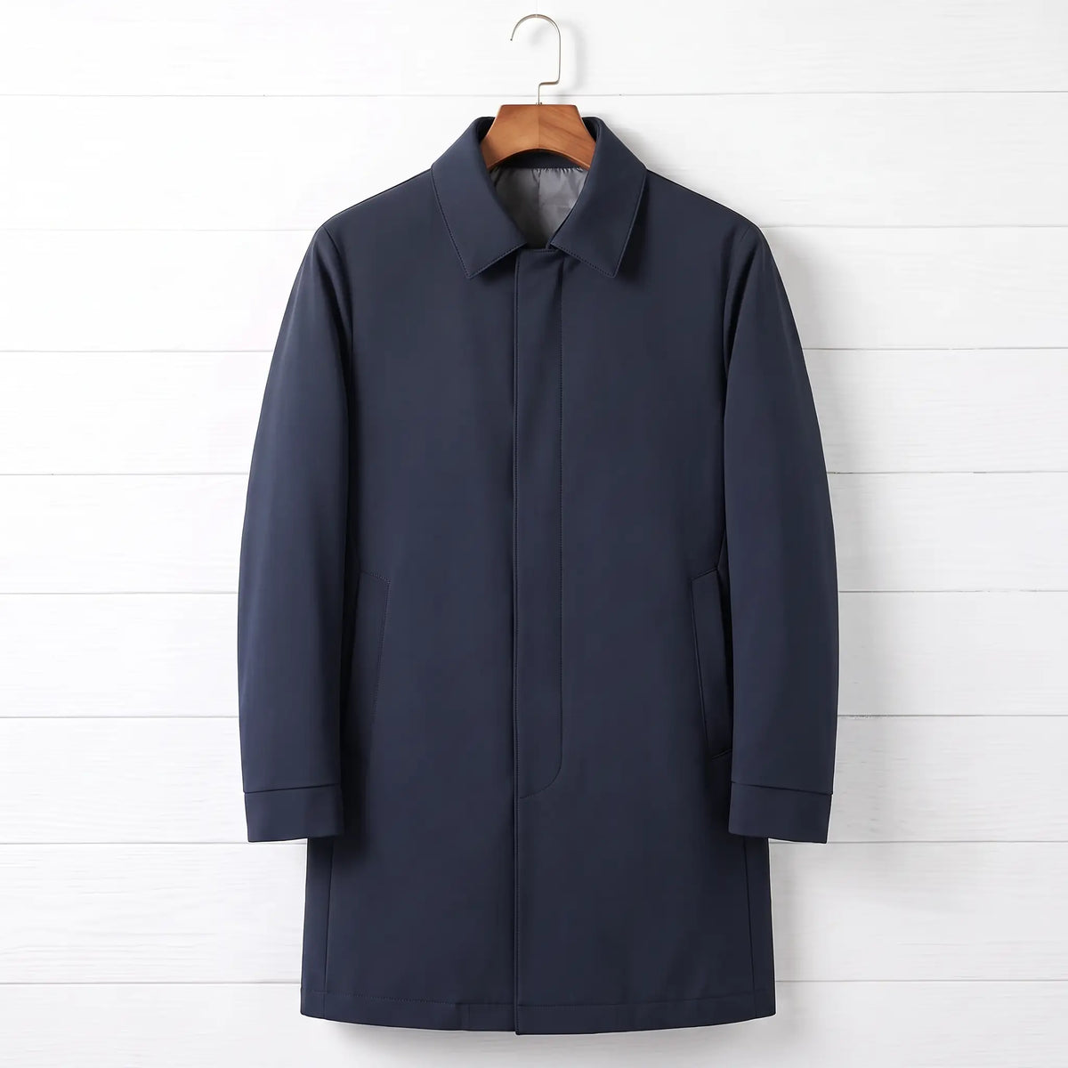 Navy blue down lined coat for men, mid-thigh car coat with hidden buttons on a wooden hanger