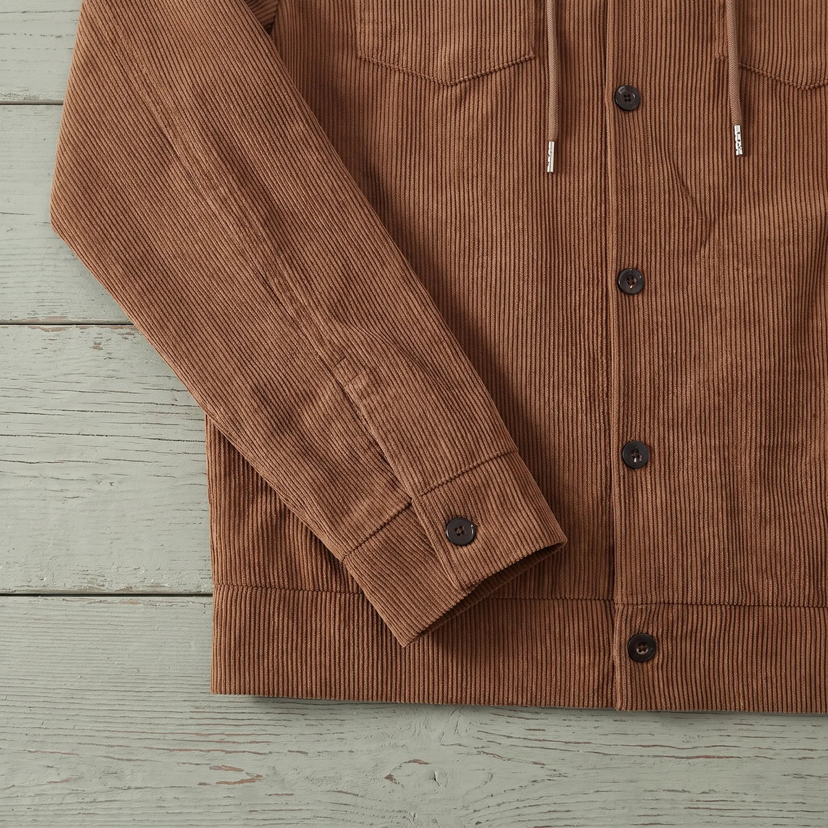 Close up of the corduroy cuff and hem band on the brown drawcord collar jacket
