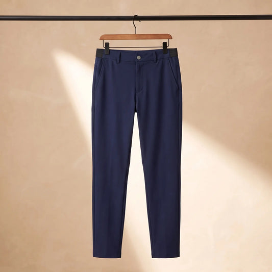 Easy waist slim trousers in navy blue with elastic back waistband, hanging on a wooden hanger