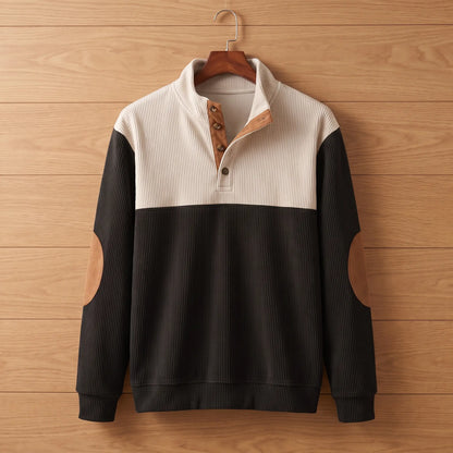 Ribbed knit pullover in black on a wooden hanger