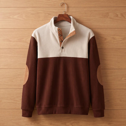 Men's red ribbed knit pullover with tan elbow patches and stand collar on a wooden hanger