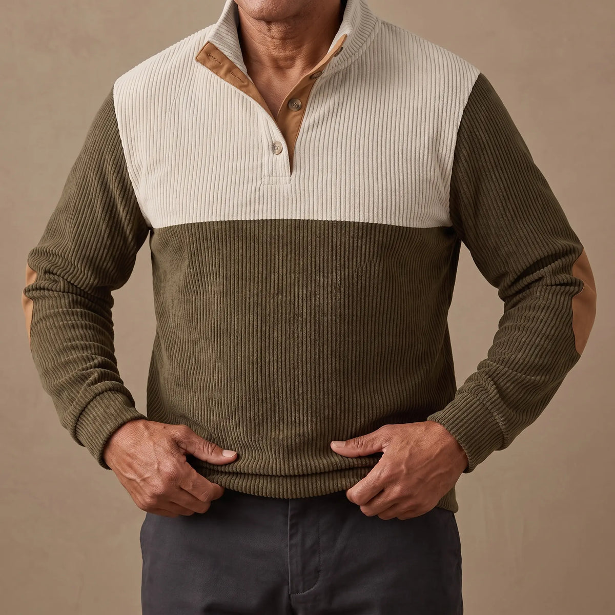 Pullover worn, hands easing the ribbed hem down