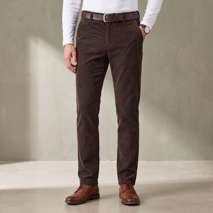 Brown fine wale corduroy trousers worn with a brown leather belt and derby shoes