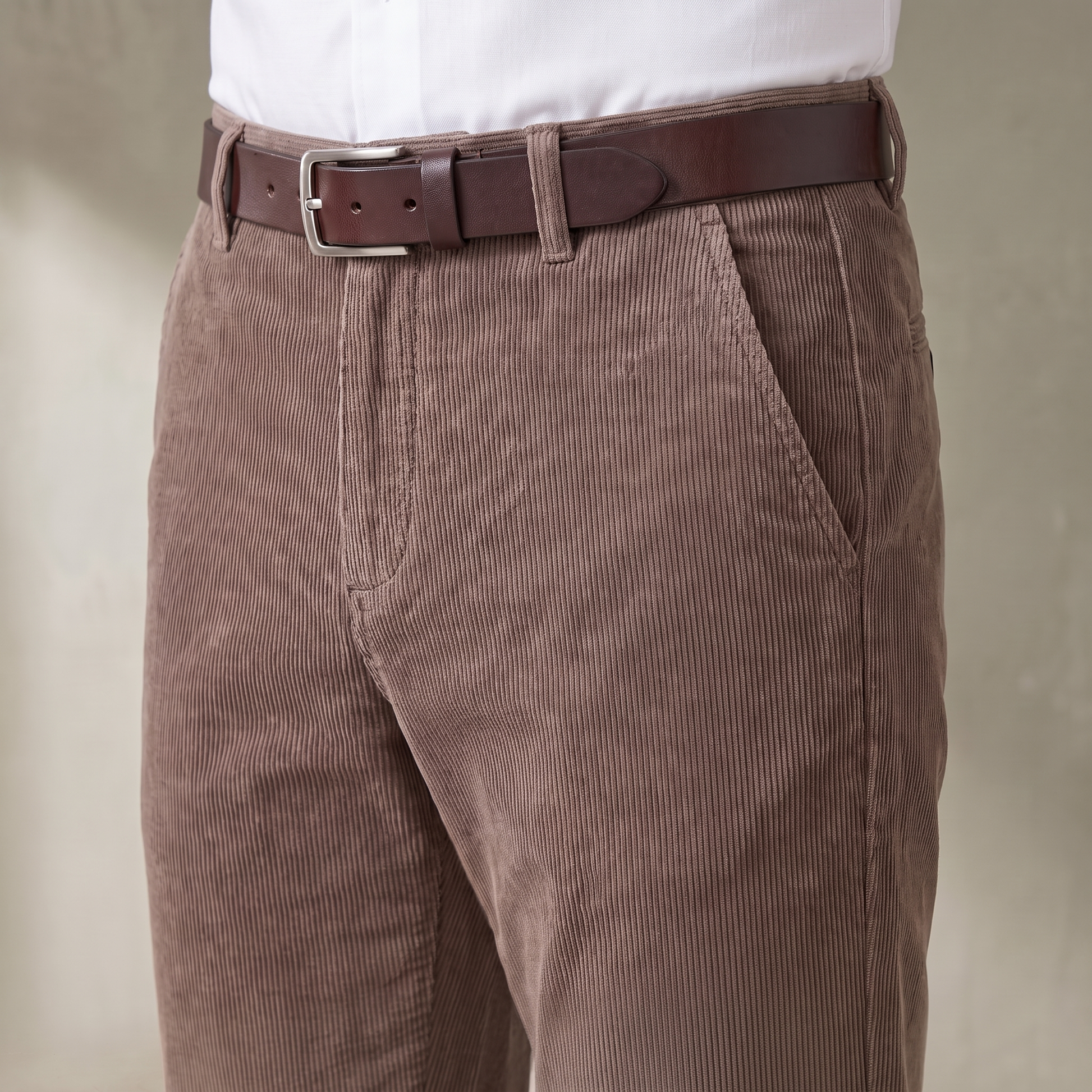 Close-up of the corduroy trouser waistband, belt loops, zip fly and slanted side pocket