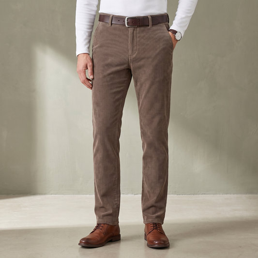 Khaki fine wale corduroy trousers worn with a brown leather belt and derby shoes