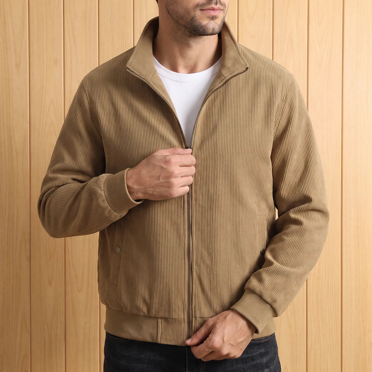 Man zipping up khaki corduroy jacket