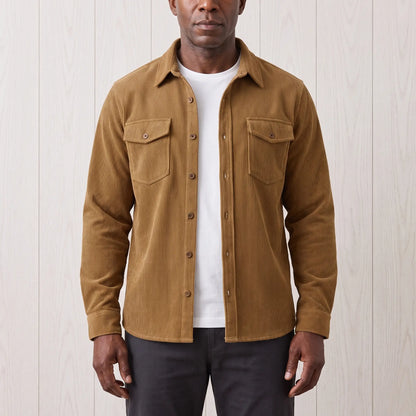 Man wearing the Fine Cord Overshirt in brown, a corduroy shirt jacket with two flap chest pockets, open over a white tee