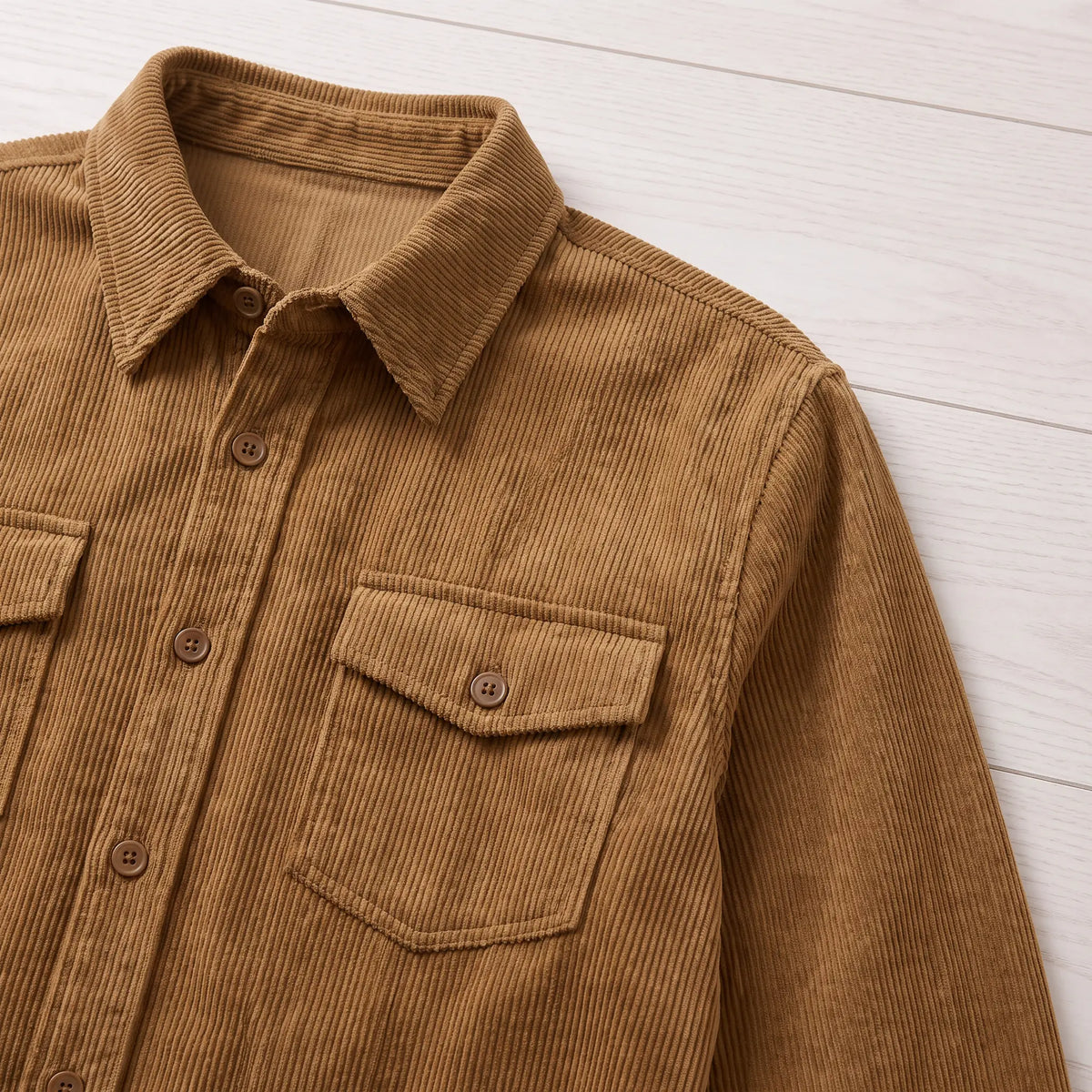 Close-up of the brown Fine Cord Overshirt showing the collar and buttoned flap chest pocket