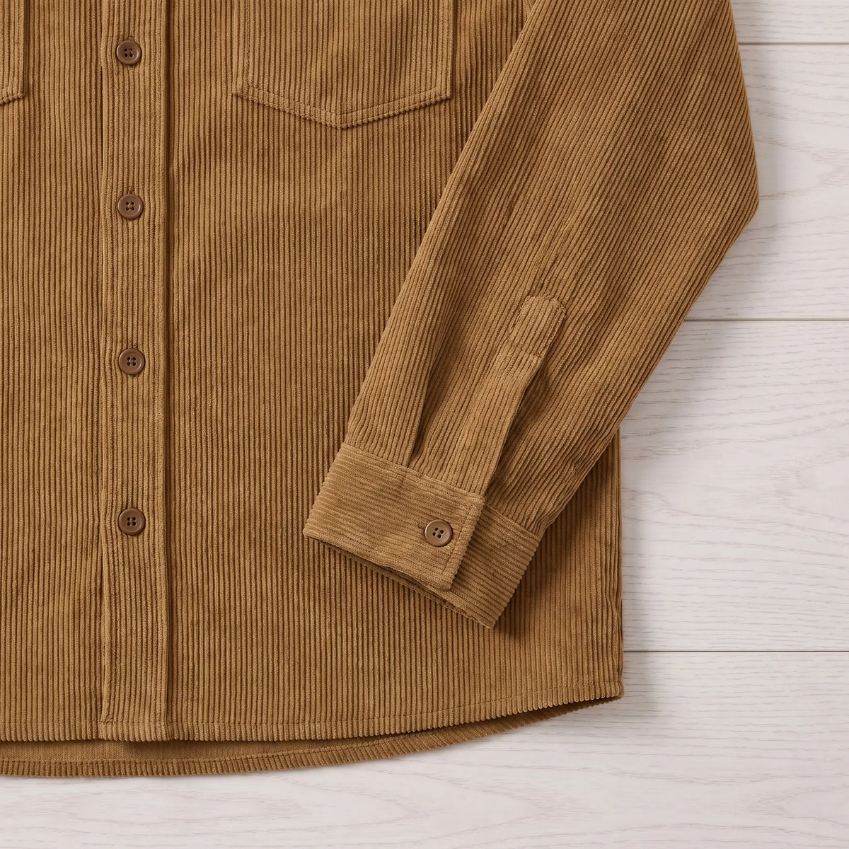 Close-up of the brown Fine Cord Overshirt showing the button front, hem and buttoned cuff