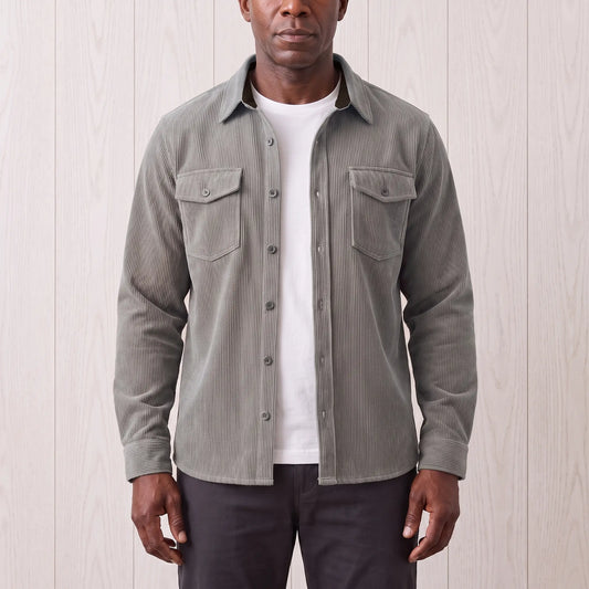 Man wearing the Fine Cord Overshirt in grey, a corduroy shirt jacket open over a white tee