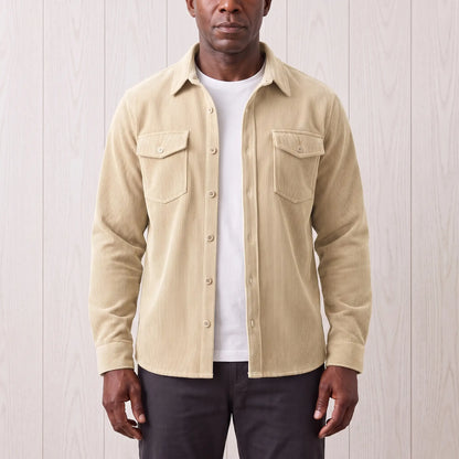 Man wearing the Fine Cord Overshirt in white, a cream corduroy shirt jacket open over a white tee