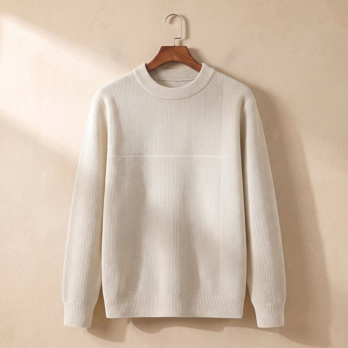 Men's cream fine rib crew-neck sweater on a wooden hanger