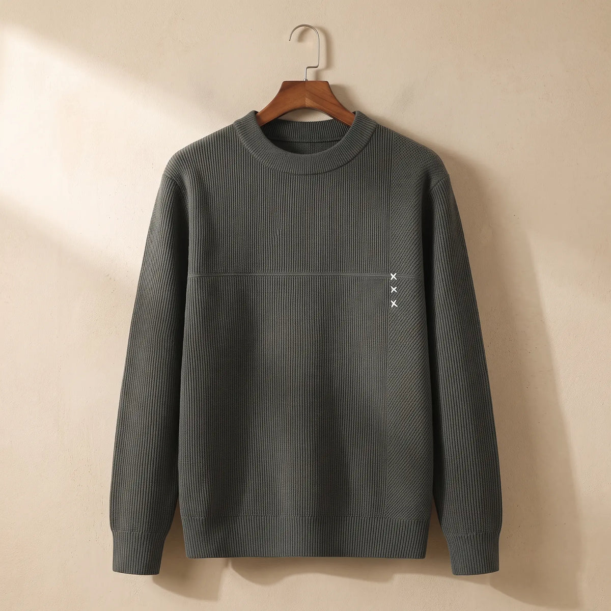 Men's green fine rib crew-neck sweater with chest seam on a wooden hanger