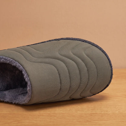 Close-up of green quilted slipper toe showing wave stitching and plush lining