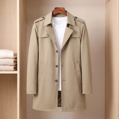 Flap Pocket Coat in khaki, a slim mid-length single-breasted trench coat with epaulettes and hip flap pockets on a wooden hanger