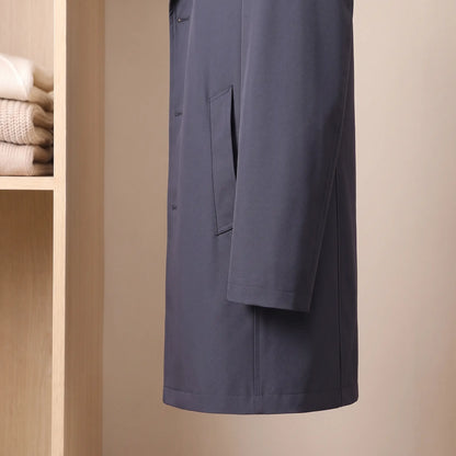 Side view of the sleeve, hip flap pocket and straight hem on the navy Flap Pocket Coat