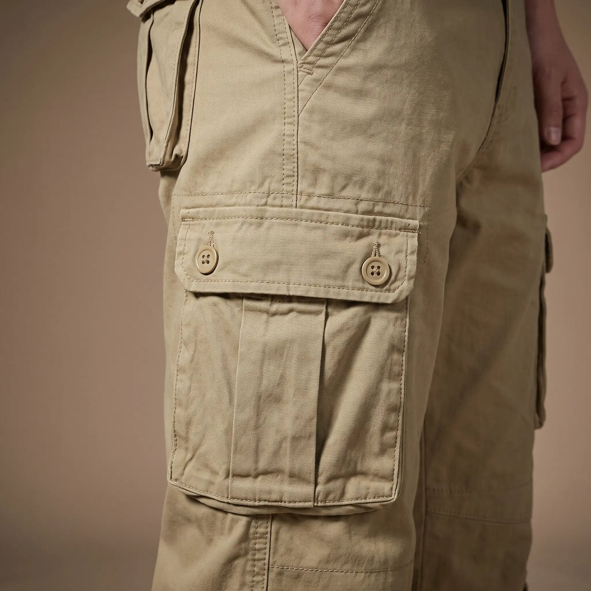 Close up of the FLAP POCKET TROUSERS thigh cargo pocket with button flap