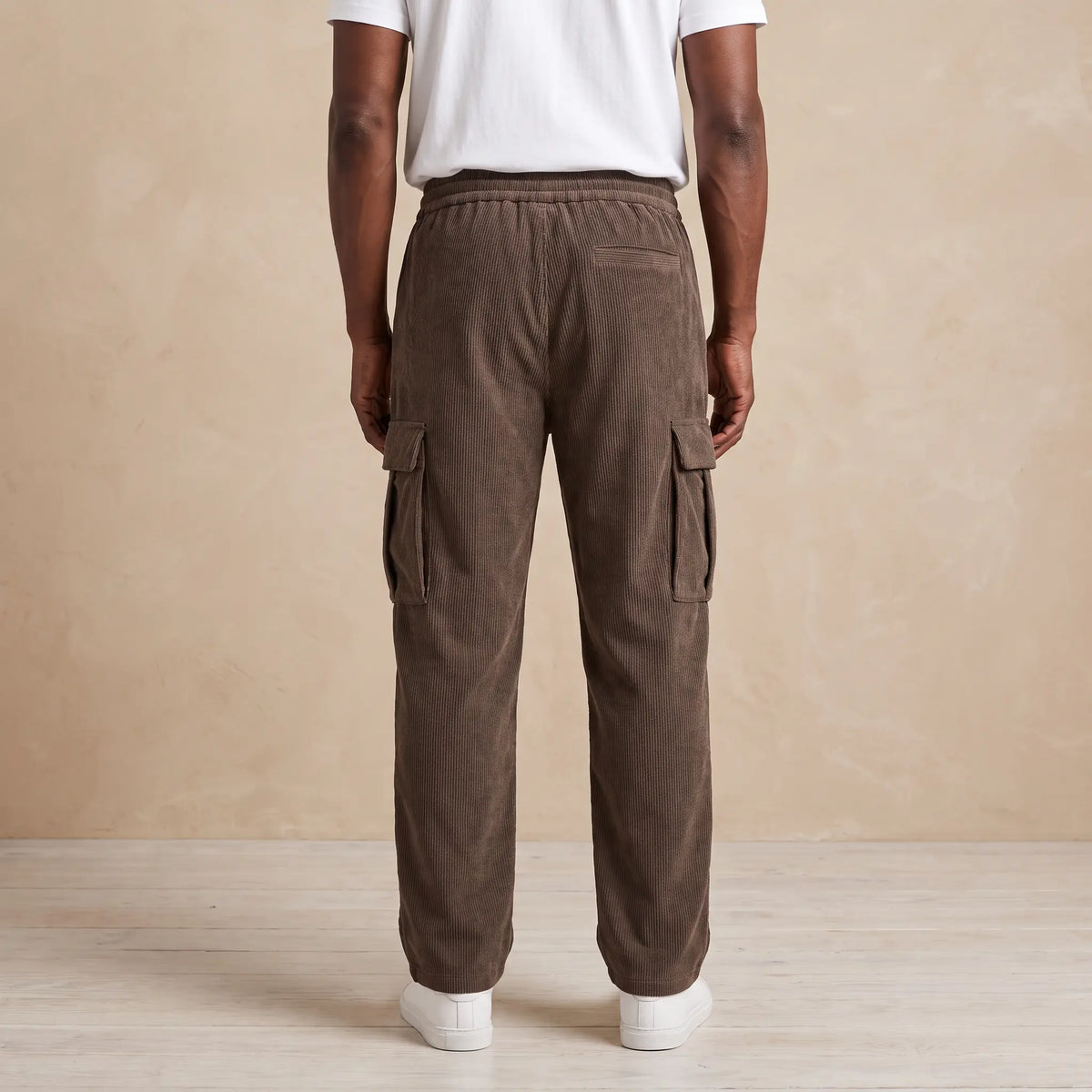 Back view of a man wearing the brown fleece cord cargos