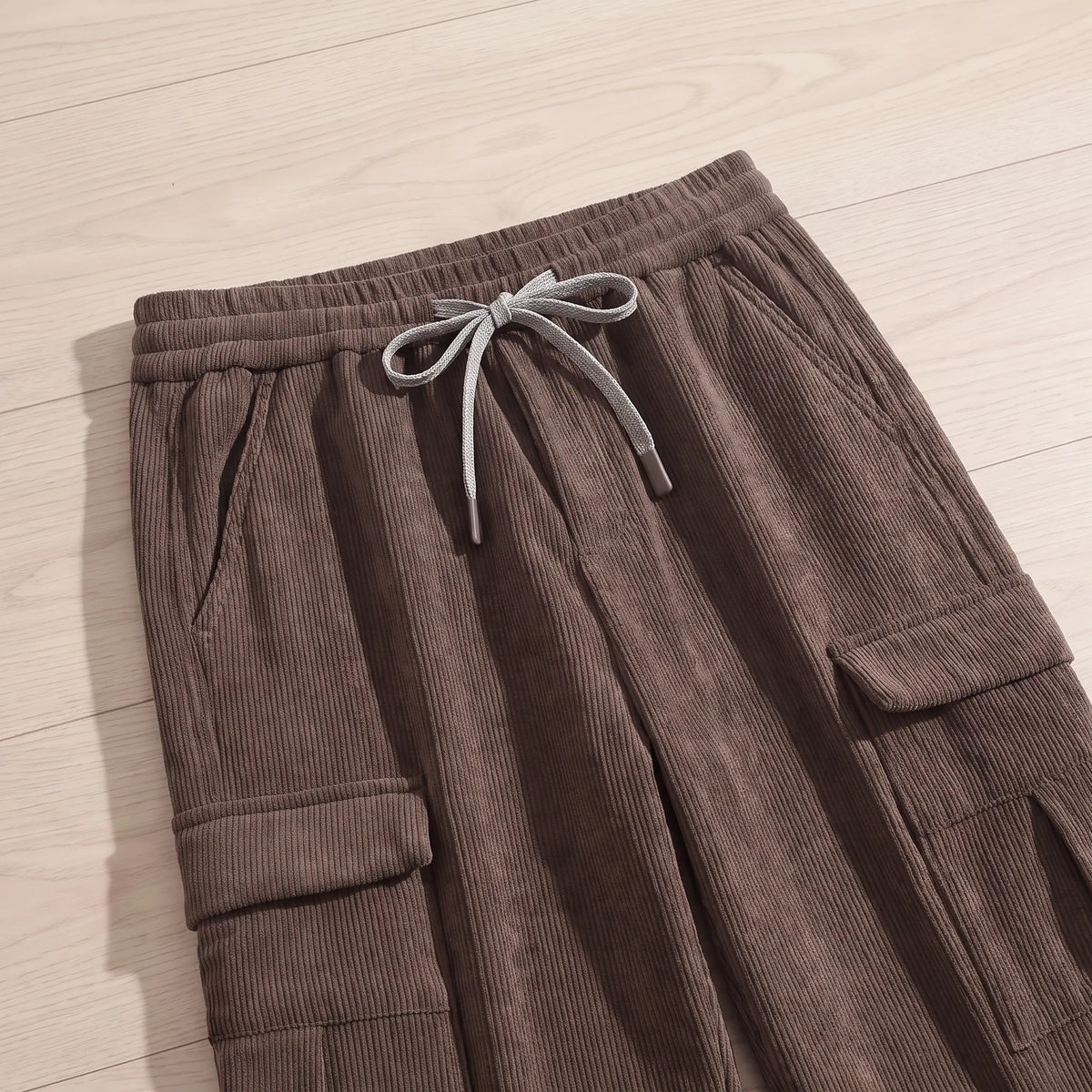 Close-up of the brown fleece cord cargos drawcord waist and pockets