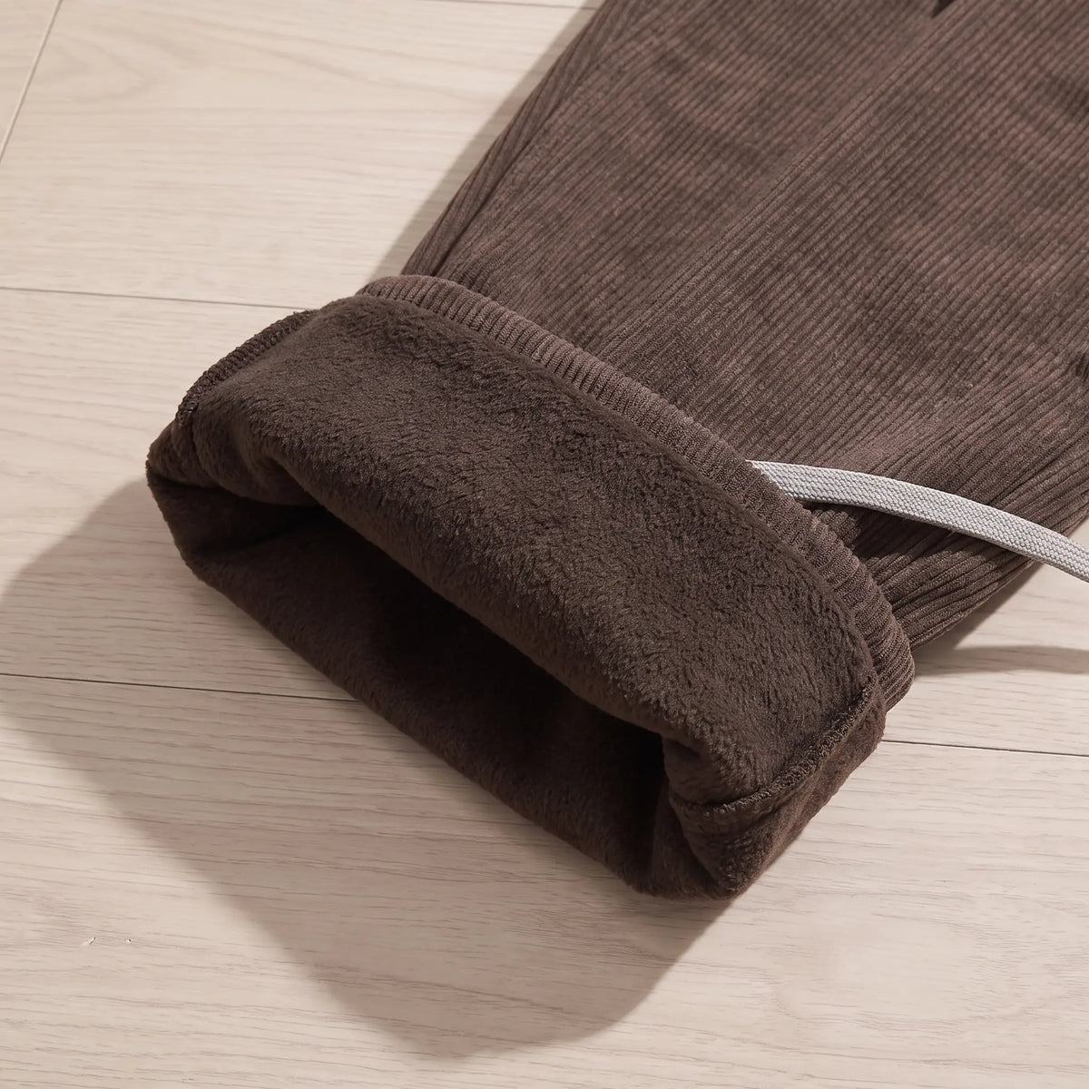 Close-up of the fleece lining inside the brown corduroy cargo trousers