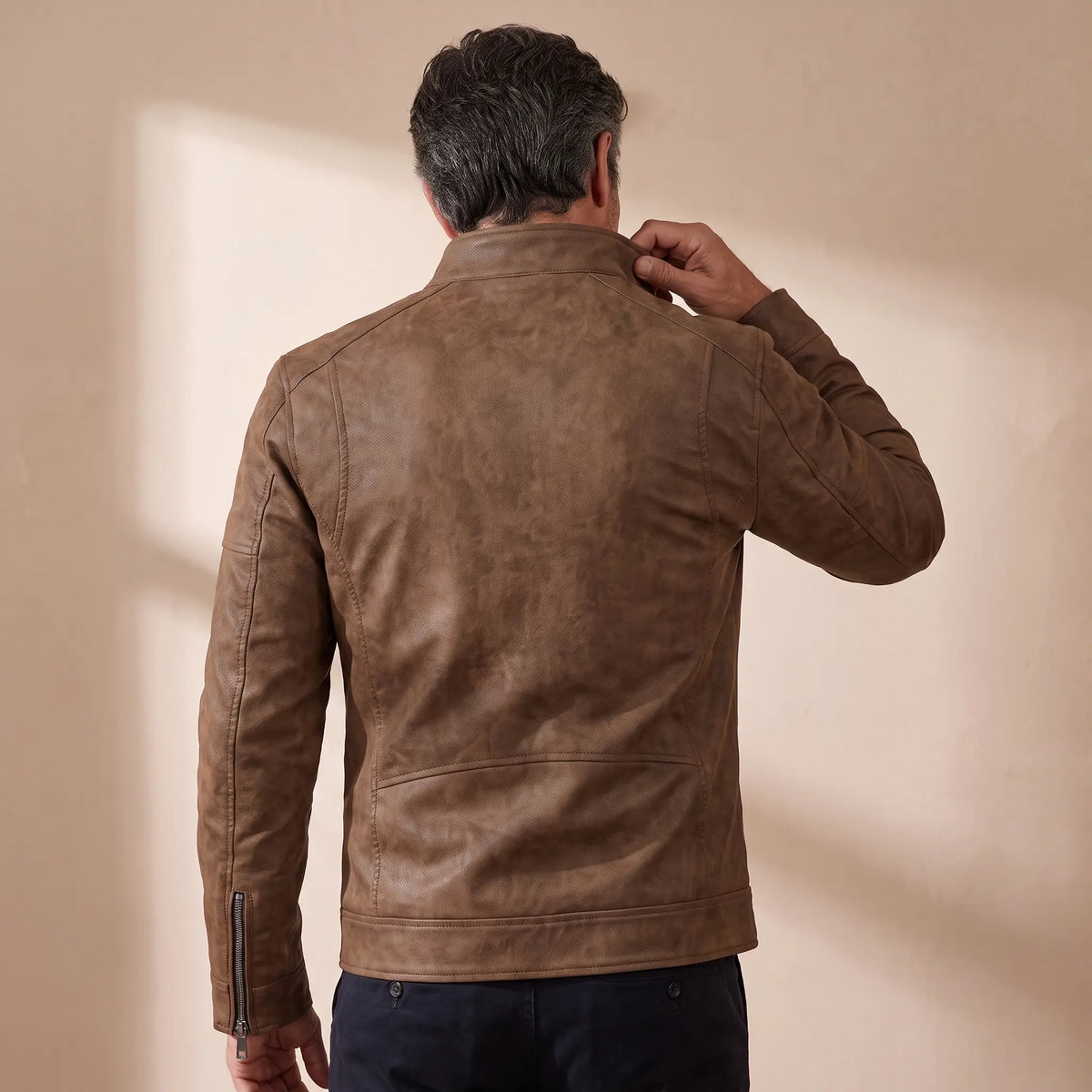 Back view of a man wearing the brown fleece moto jacket