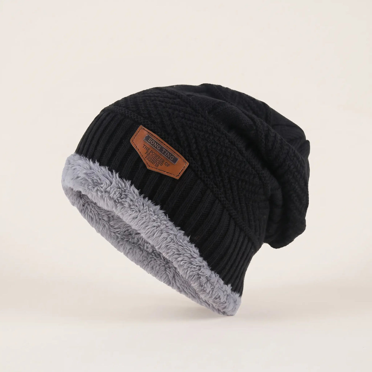 Men's black fleece-lined slouch beanie with textured knit, grey fleece cuff and leather patch