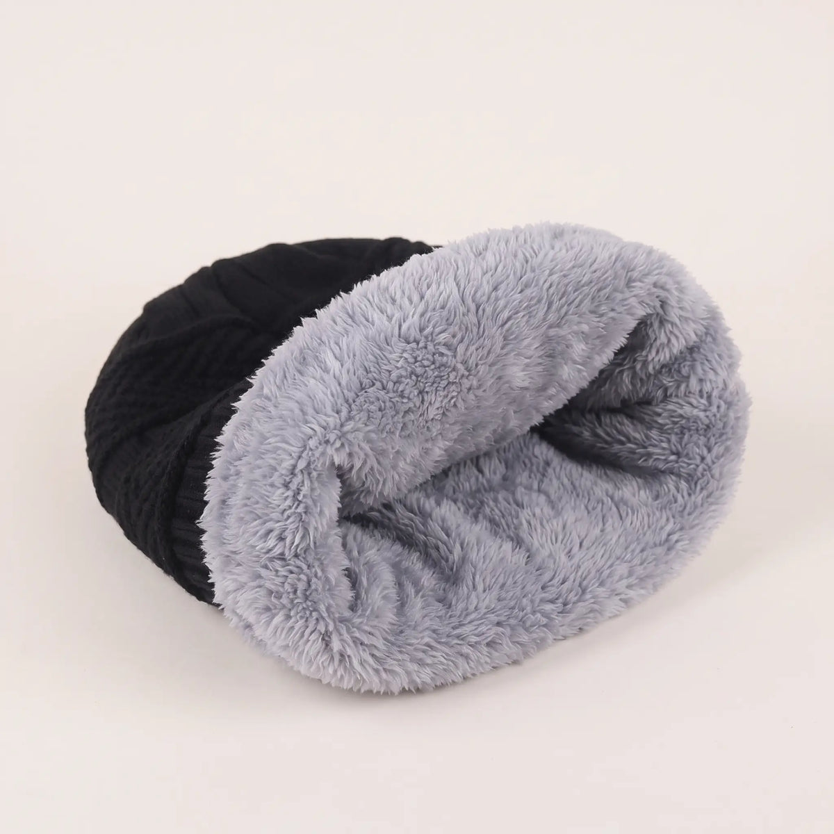 Inside of black slouch beanie showing the soft grey fleece lining
