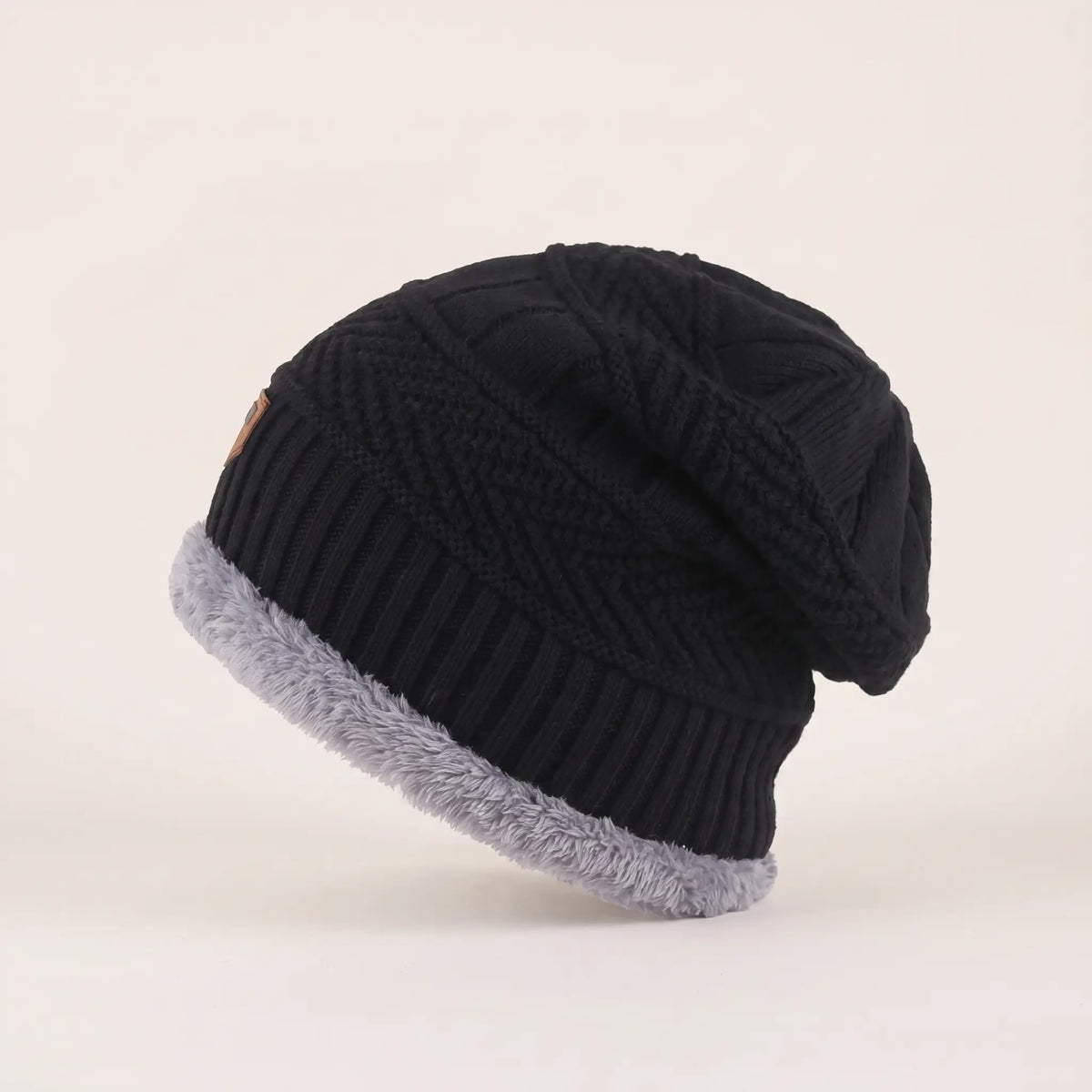 Side view of black fleece-lined slouch beanie showing the relaxed slouch and fleece cuff
