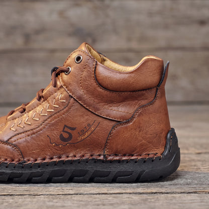 Close-up of the padded collar and hand-stitched sole edge on the brown men's ankle boot