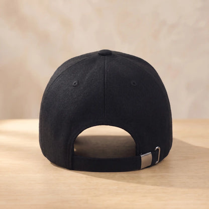 Back view of black winter baseball cap showing adjustable strap with metal slide buckle