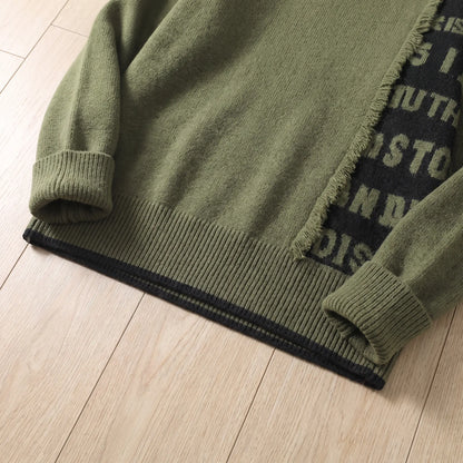 Close-up of the green frayed panel knit layered hem and ribbed cuff