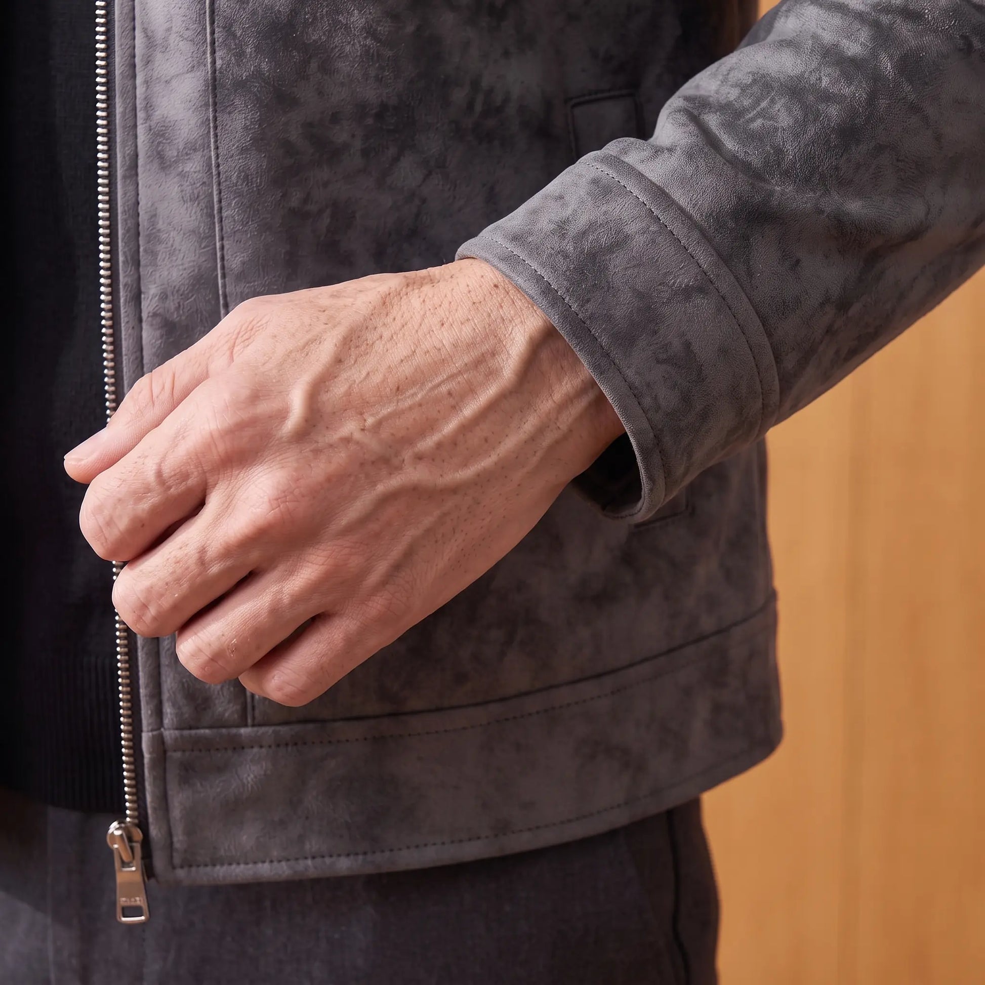 Close-up of the frosted suede jacket cuff and hem