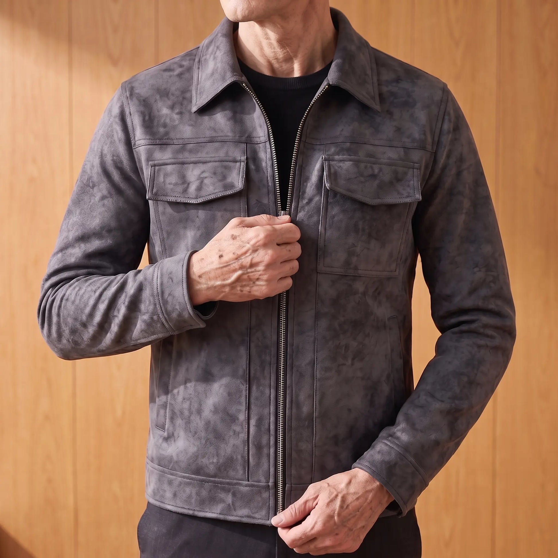 Older man zipping up the frosted suede jacket, close crop on hands and zip