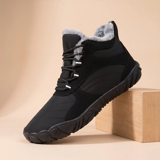 Men's black plush-lined wide toe winter boot on an oak block