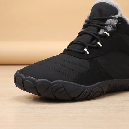 Close-up of the wide toe and deep tread sole on the black winter boot