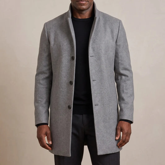 Grey funnel neck wool overcoat worn open over a black tee