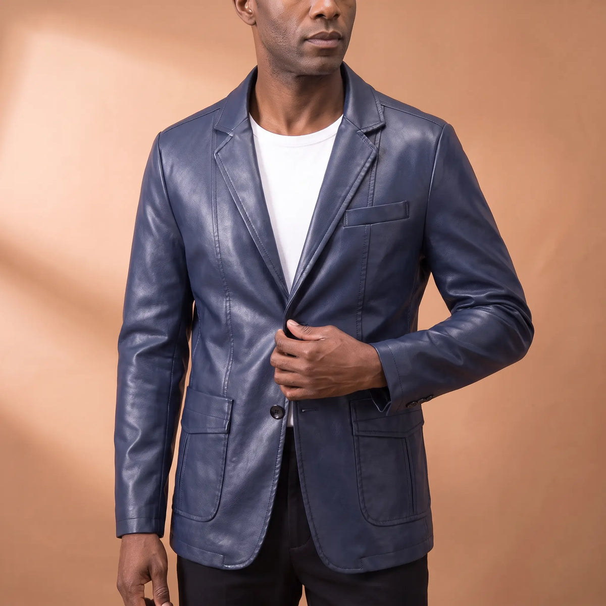 Man wearing the Glossy Finish Blazer over a white tee