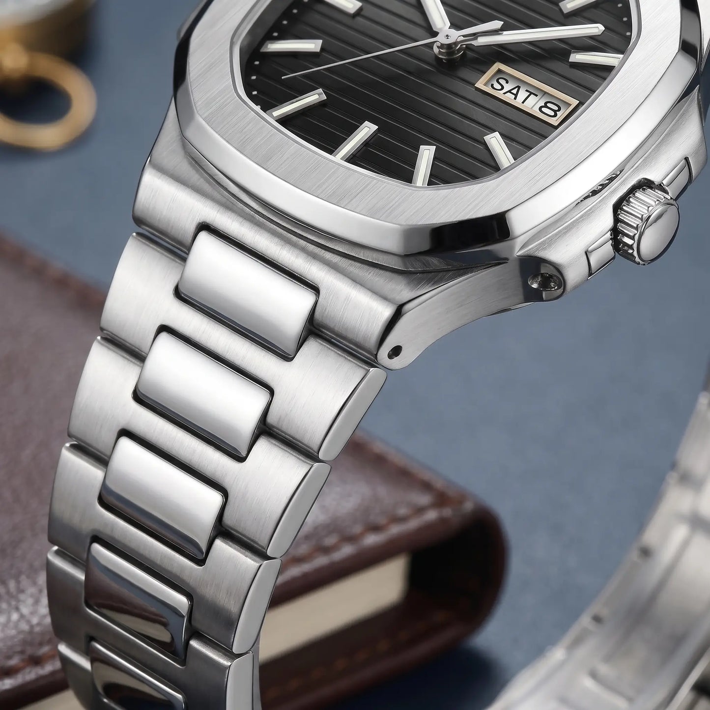 GLOW MARKER WATCH case close-up - fluted crown, stepped case side and flat-link steel bracelet