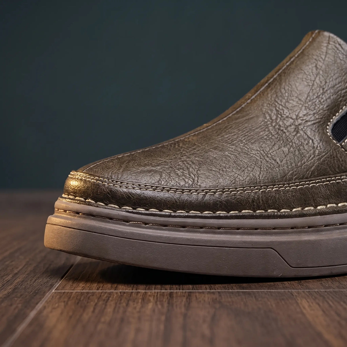 Front close up of brown leather loafers showing the vamp stitching and layered platform sole