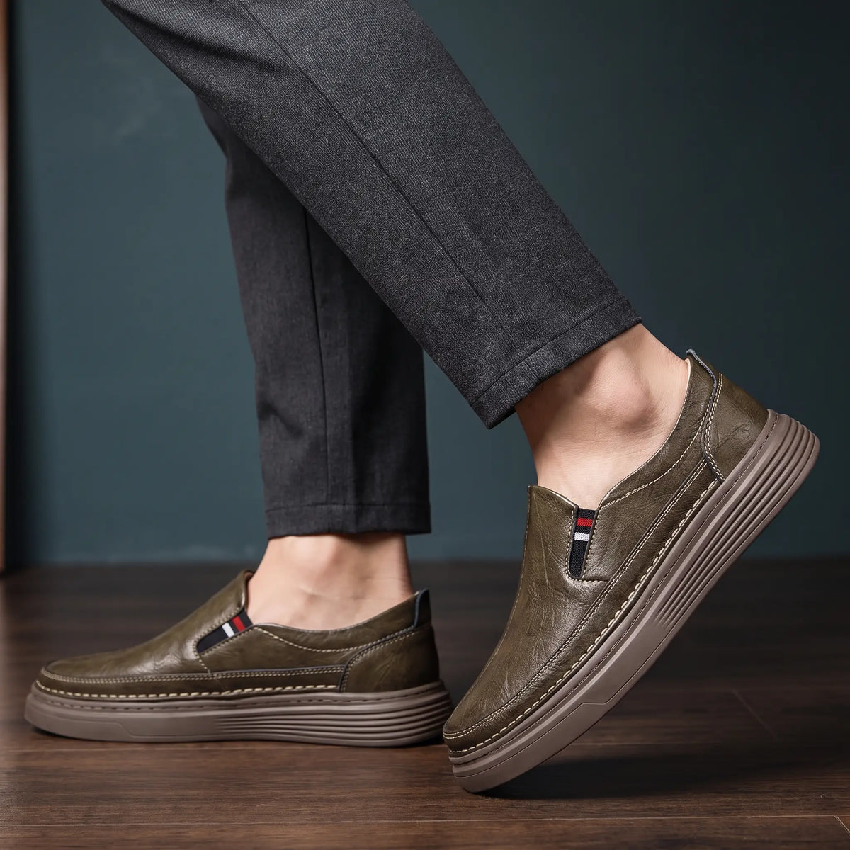 Man wearing brown genuine leather slip on loafers with charcoal tapered trousers