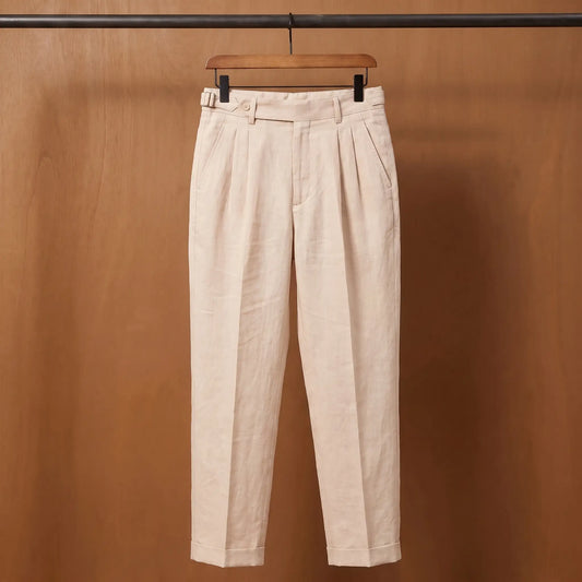 Gurkha pleated trousers in peach on a wooden hanger