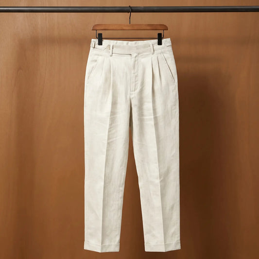 Gurkha pleated trousers in stone on a wooden hanger