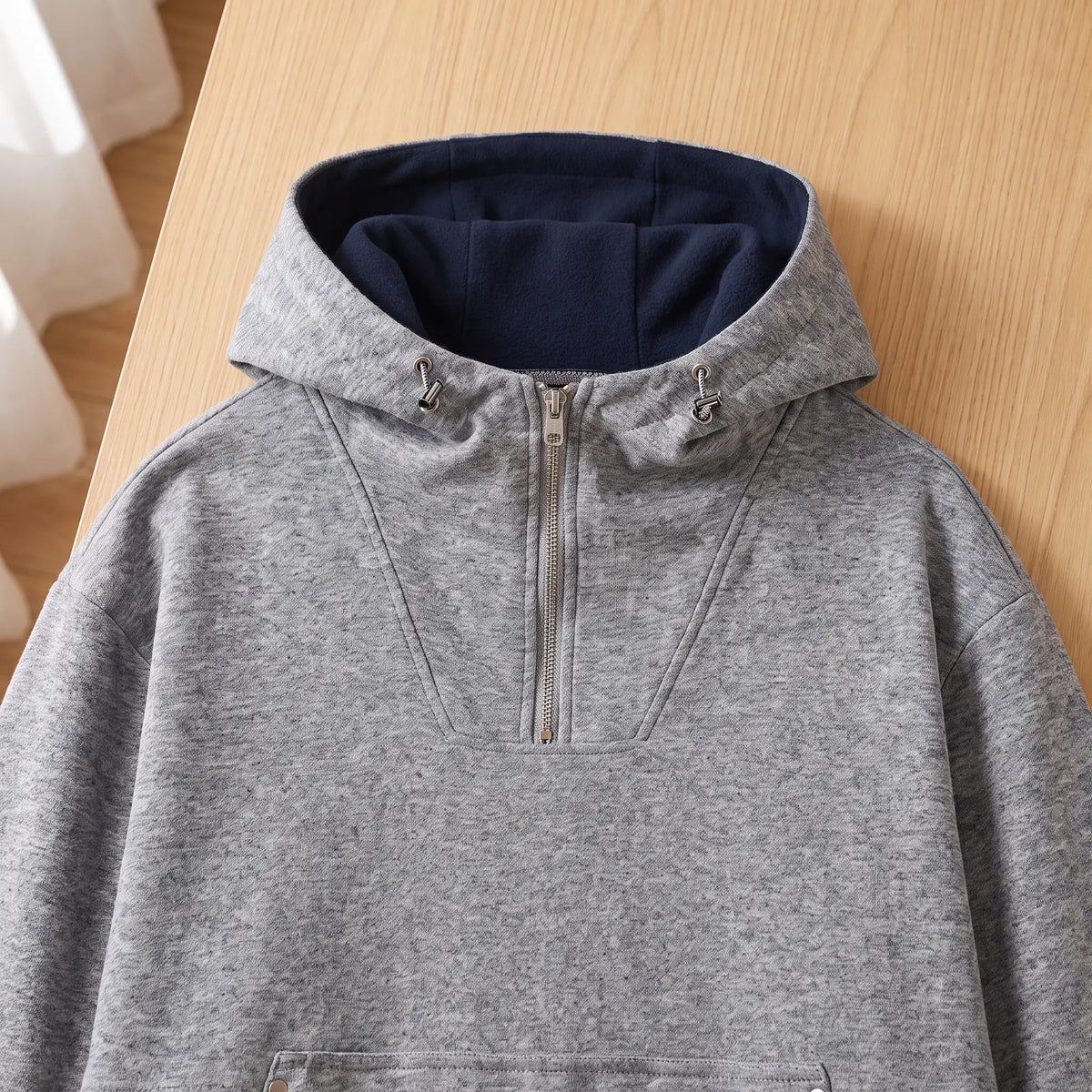 Close-up of the grey heather half-zip hoodie hood lining and zip neck